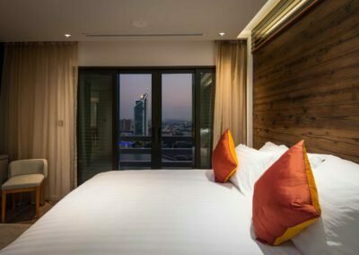 Interior photo of a Bedroom at Sanintara Condominium with a view over the skyline of Bangkok, Thailand.