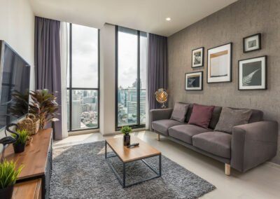 Living room at Noble Phloem Chit Condominium with a view on the Skyline of Bangkok. Airbnb photography service in Thailand.