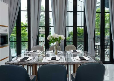 Elegant dining area with large windows. Photographed by Real Estate Photography Thailand.