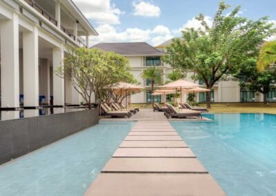 Modern hotel pool with lounge chairs Hotel photography service by professional hotel photographer in Bangkok, Thailand.