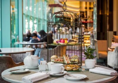 Afternoon tea set up in the lobby of Chatrium Riverside Hotel, Bangkok. Professional hotel photography service all over Thailand.